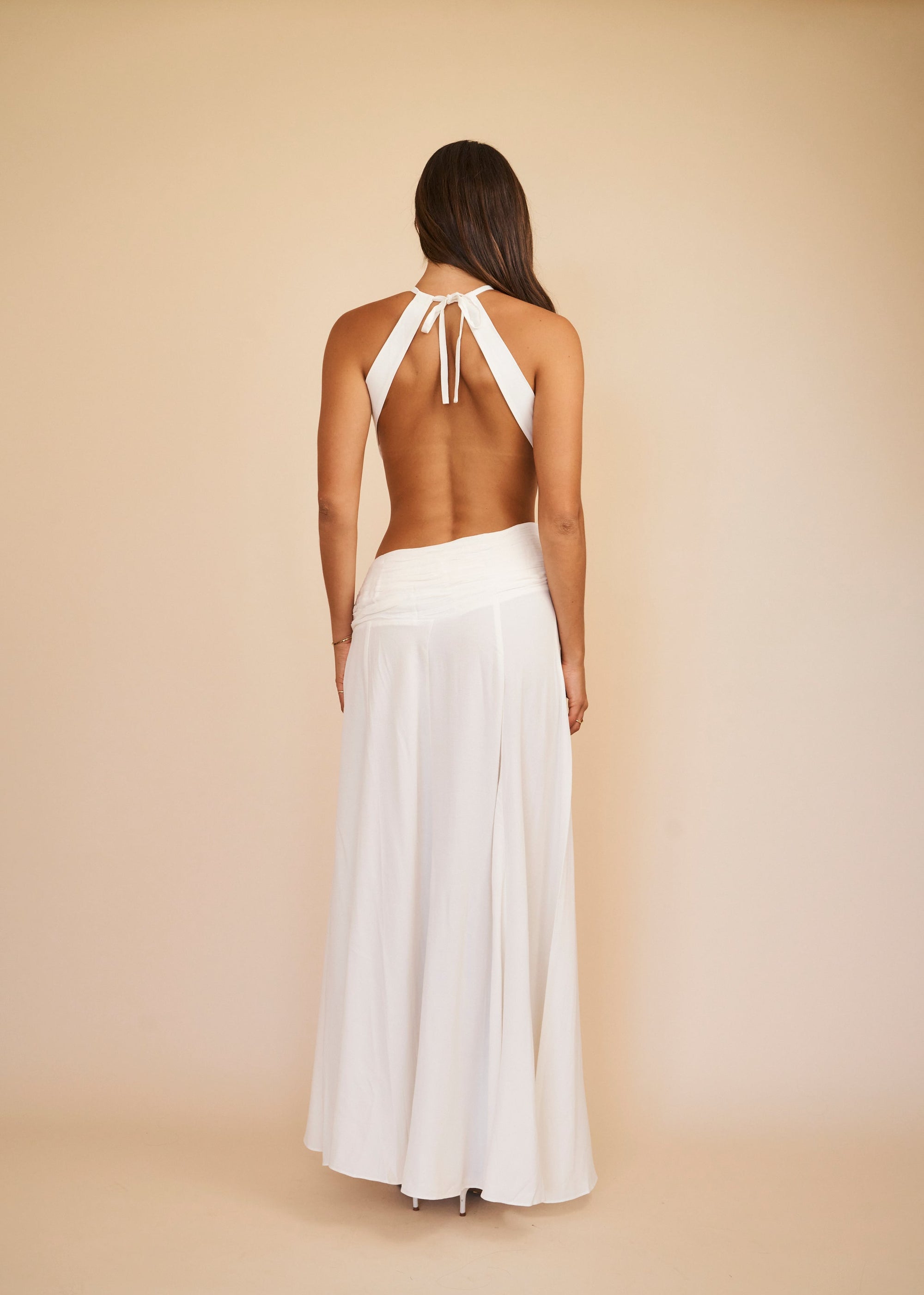 white co ord set with a tie open back top and draped maxi skirt